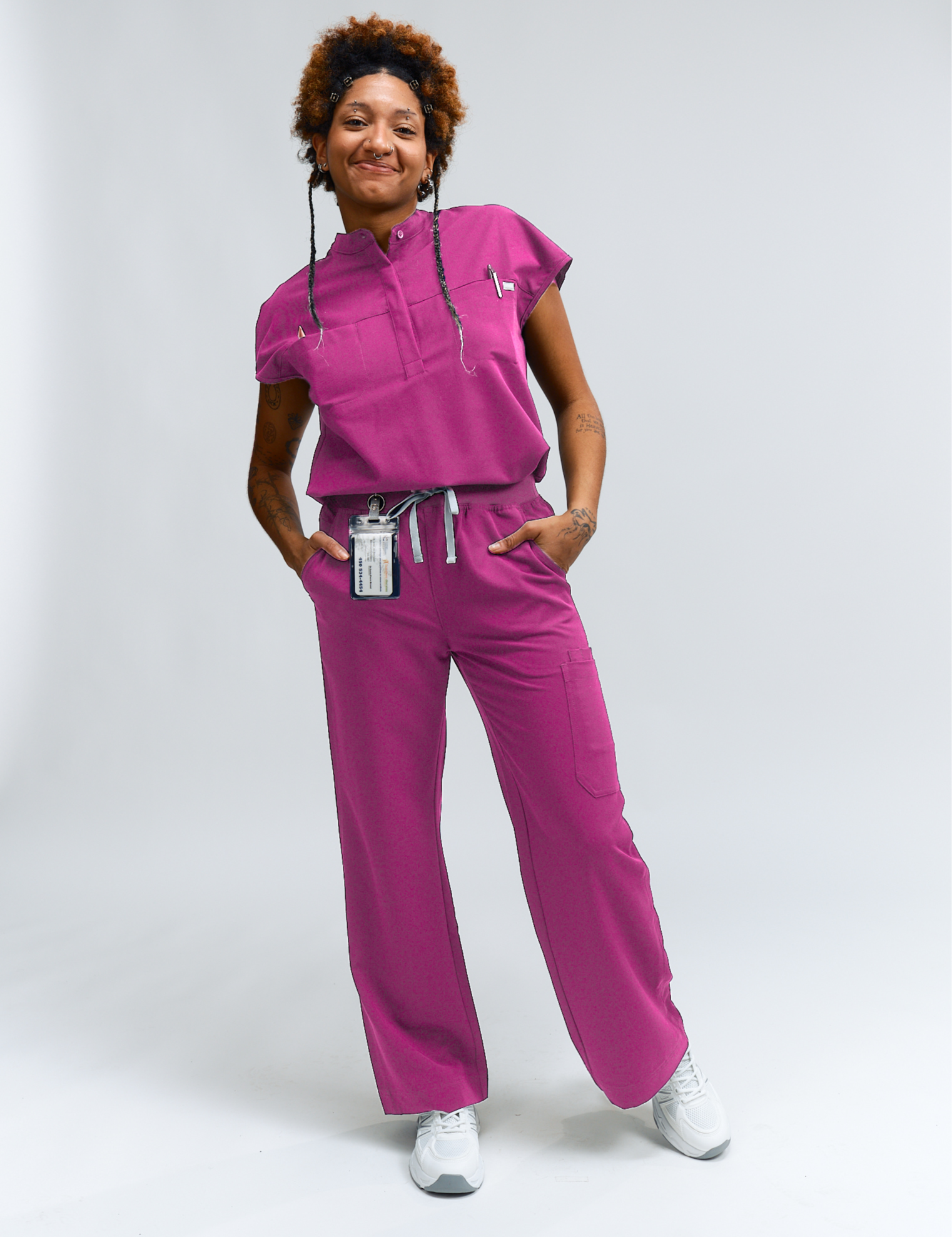 Person wearing a pink medical uniform on a white background